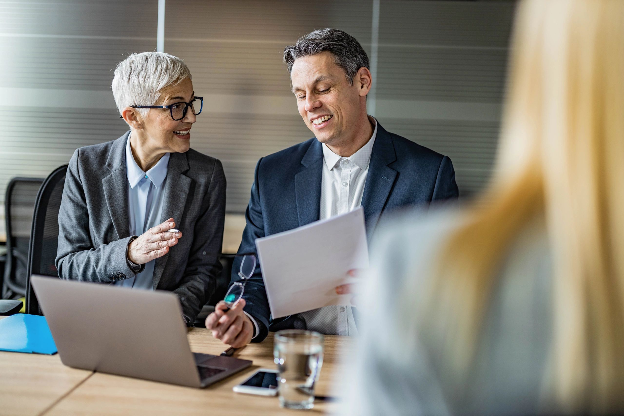 Business colleagues reviewing paperwork together in an office meeting