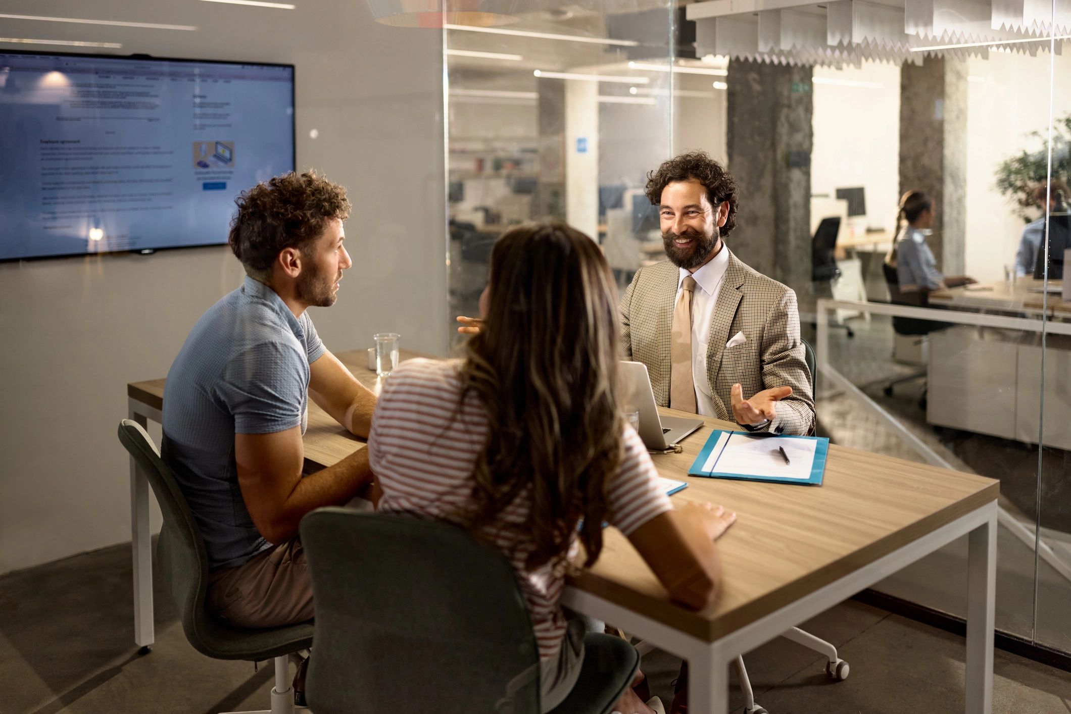 Consultant speaking with clients during an office meeting